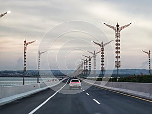 Bali island highway in the evening under cloudy sky