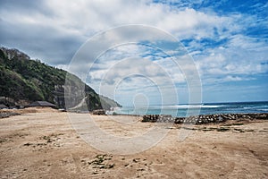 Bali seascape with huge waves at beautiful hidden white sand beach photo