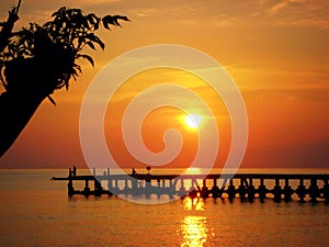 Bali sunrise over the golden ocean and jetty