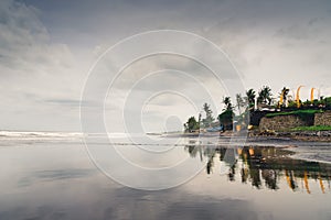 Bali temples reflection on black sand beach