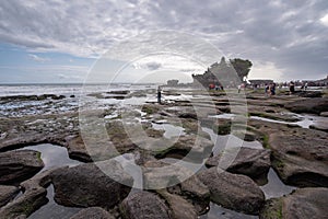 Bali Tourist take photo and sightseeing at Pura tanah lot temple famous place in Bali Indonesia