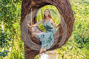 Bali trend, straw nests everywhere. Young tourist enjoying her travel around Bali island, Indonesia. Making a stop on a