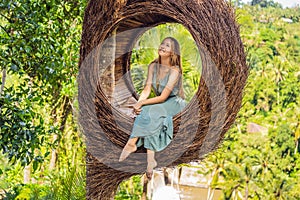 Bali trend, straw nests everywhere. Young tourist enjoying her travel around Bali island, Indonesia. Making a stop on a