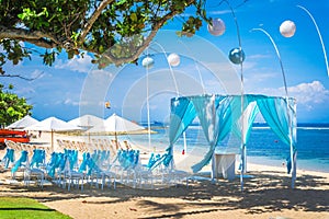 Bali tropical destination beach wedding with canopy, chairs and decoration and the sea