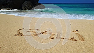 Bali written in sand on beach