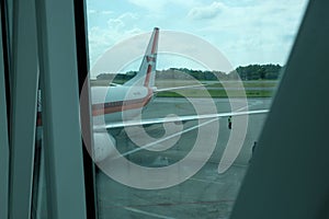 BALIKPAPAN/INDONESIA - FEBRUARY 16, 2016: An Indoneian airline, Garuda Indonesia, aircraft tail logo from airport window