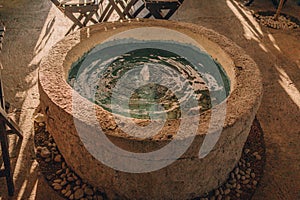 Balinese decorative garden stone basin with water