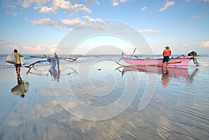 Balinese fishermen were preparing their boats before heading for the sea