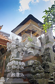 Balinese Hindu family shrine or temple ornately covered with gold showing many effigies of gods and demons.