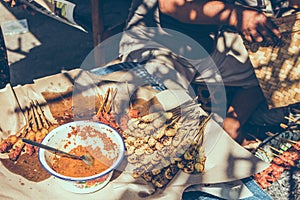 Balinese indonesian street food chicken sate. Preparing chicken sate. Bali island.