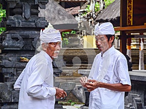Balinese men at the Tanah Lot temple in Bali, Indonesia