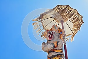 Balinese monkey Hanuman under ceremonial umbrella