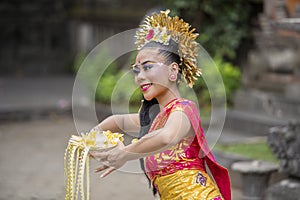 Balinese pendet dancer performing in temple