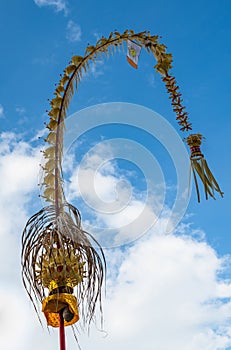 Balinese Penjor over blue sky, traditional decorated bamboo pole, Indonesia