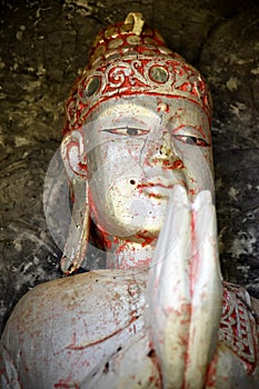 Balinese spiritual wooden buddha statue with praying hands