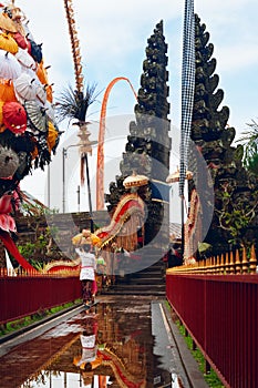 Balinese woman carry traditional religious offering to temple for ceremony