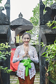 balinese woman with traditional clothes and welcome gestures smi