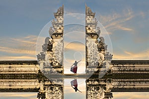 Balinese women in traditional costumesis standing in the gate of Lempuyang temple on Bali island, Indonesia