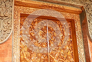 Balinese wood carved doors with traditional local ornaments. Local traditions and craftmanship concept