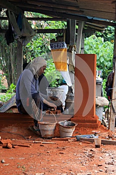 Balinese worker constructing decorative element in Bali