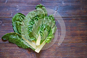 Balkan cuisine. Blitva - popular leafy vegetables. Dark rustic background, flat lay, free space for text