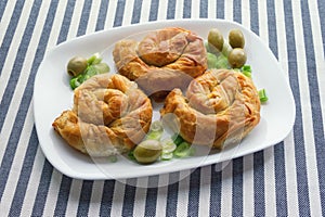 Balkan cuisine. Burek - popular national dish. Three round burek on white plate