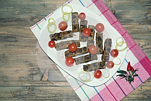 Balkan cuisine. Cevapi - grilled dish of minced meat.  Free space for text