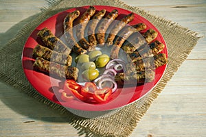 Balkan cuisine. Cevapi and kobasica - grilled dish of minced meat. Rustic background