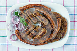 Balkan cuisine. Cevapi, kobasica and pljeskavica - grilled dish of minced meat. Flat lay