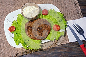 Balkan cuisine. Pljeskavica - grilled dish of minced meat, and kajmak - milk cream photo