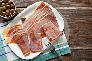 Balkan cuisine . Slices of prsut: dry-cured ham, prosciutto. Copy space
