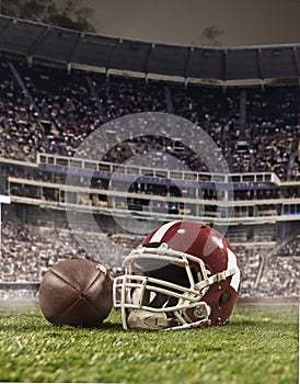 The ball of american football players and helmet on stadium background