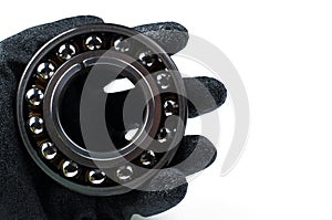 Ball bearing and gloves isolated on white background.Copy space