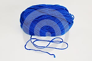 Ball of blue yarn, on white background.