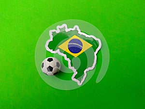 ball and brazil flag sticker is on a green