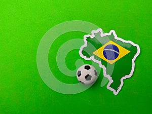 ball and brazil flag sticker is on a green