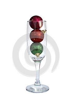 Christmas toys in a glass goblet on a white background