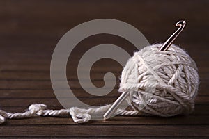 Ball of cream yarn with crochet hook