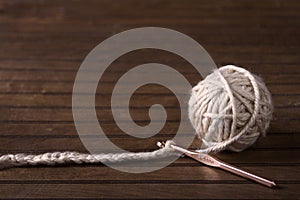 Ball of cream yarn with crochet hook