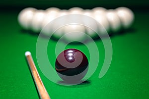 Ball is displayed on the pool table against the background of other balls and cue