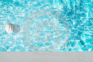 Pool float, ring floating in a refreshing blue swimming pool with palm tree leaf shadows in water
