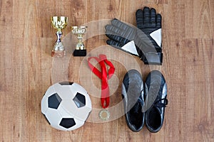 Ball, football boots, gloves, cups and medal