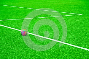 Ball on a football pitch with white stripes
