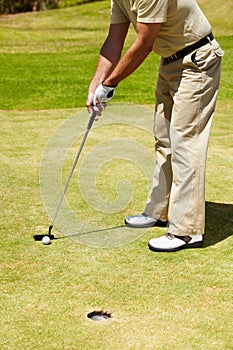 Ball, hole and man on golf course to aim for target, winning and training in contest, competition and challenge. Closeup