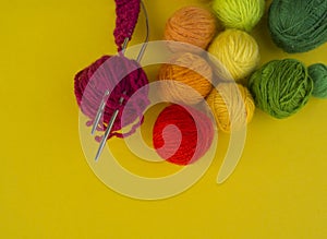 Ball for knit rainbow color a yellow background.