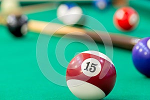 Ball number 15 on the table of billiard