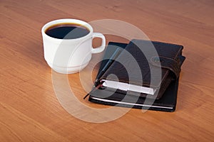 Ball pen, organizer and cup of coffee