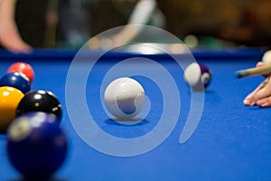 8-ball pool game player aims to shoot balls with cue