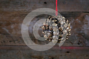 Ball Shape Pine Cone Christmas Decoration on Old Rustic Background