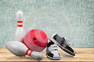 Bowling shoes and ball on background